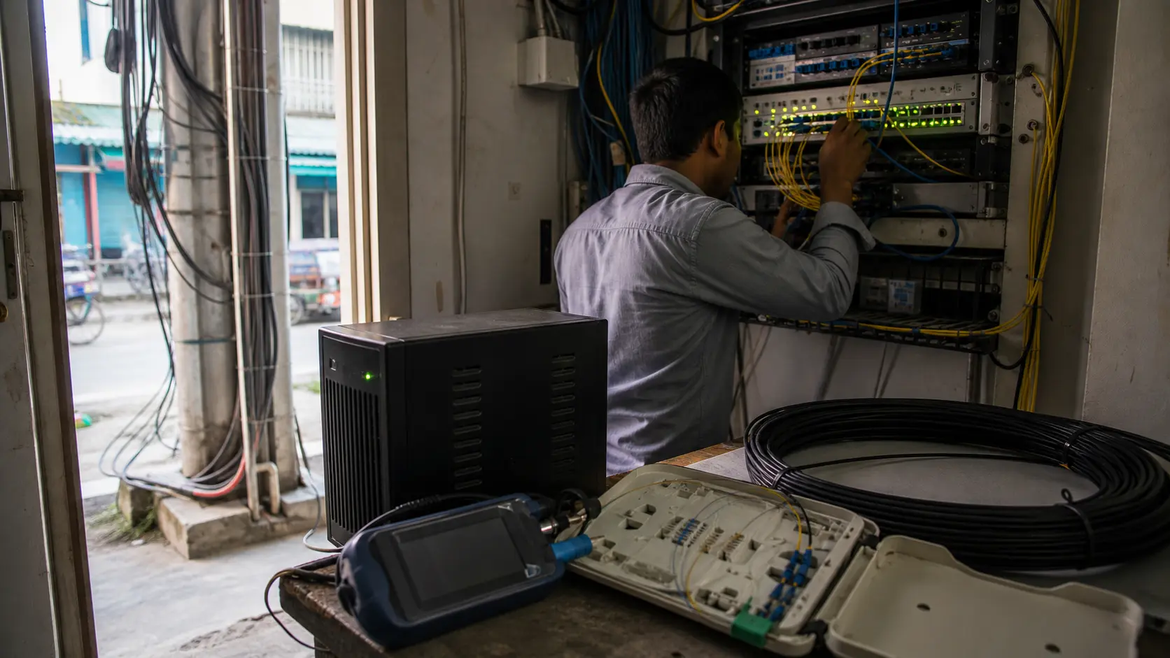 Editorial image of a compact Khulna ISP network room with routing labels for AS148974, 103.175.17.0/24, 2001:df7:e680::/48 and AS139901 upstream.