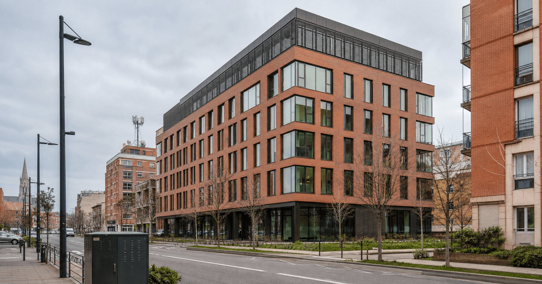 A commercial street in Toulouse with a modern office building suggestive of a technology or network company location.