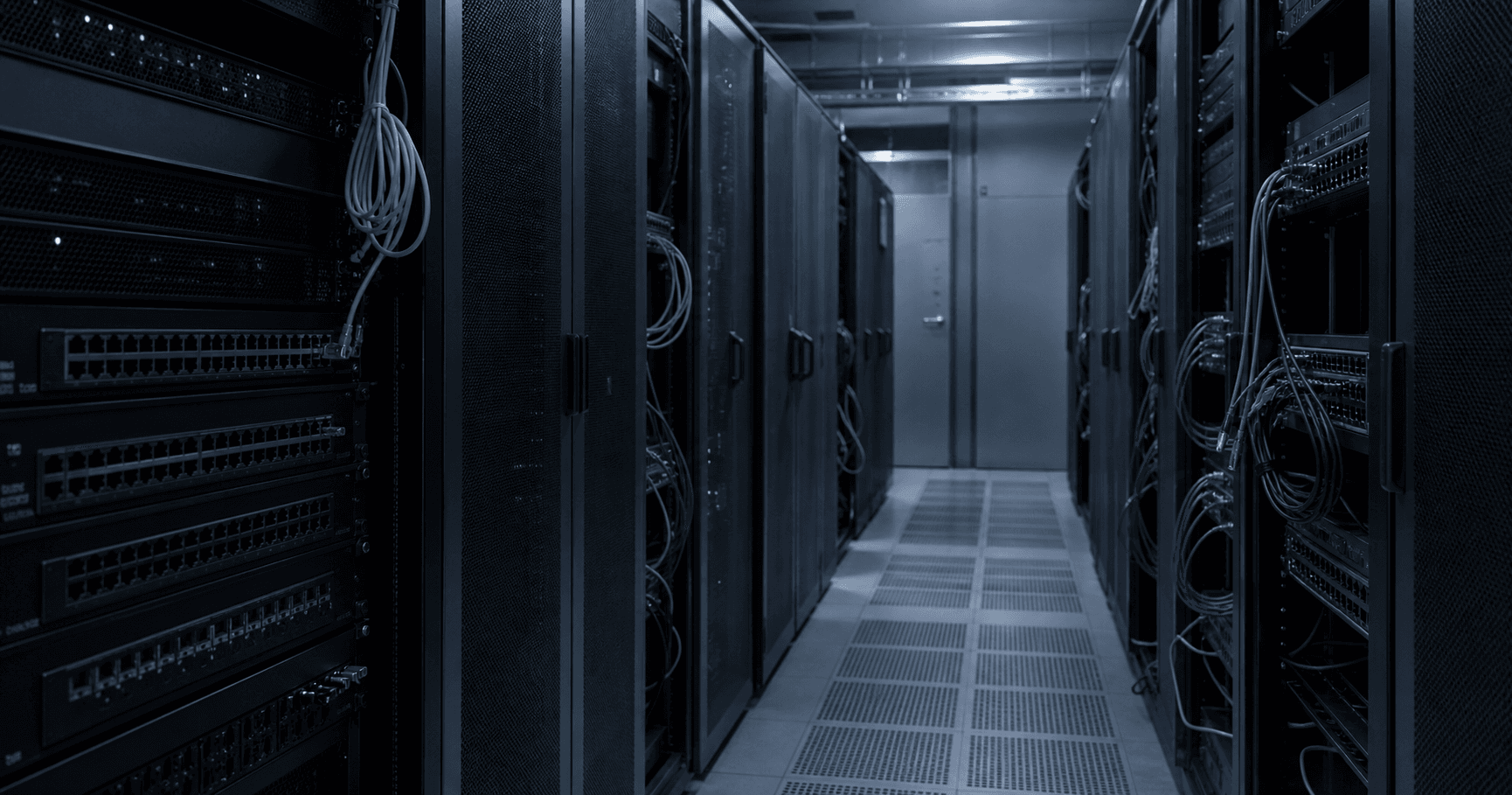 A dimly lit server room with a single inactive network rack labeled AS210642, an unplugged cable foregrounded, conveying dormancy.