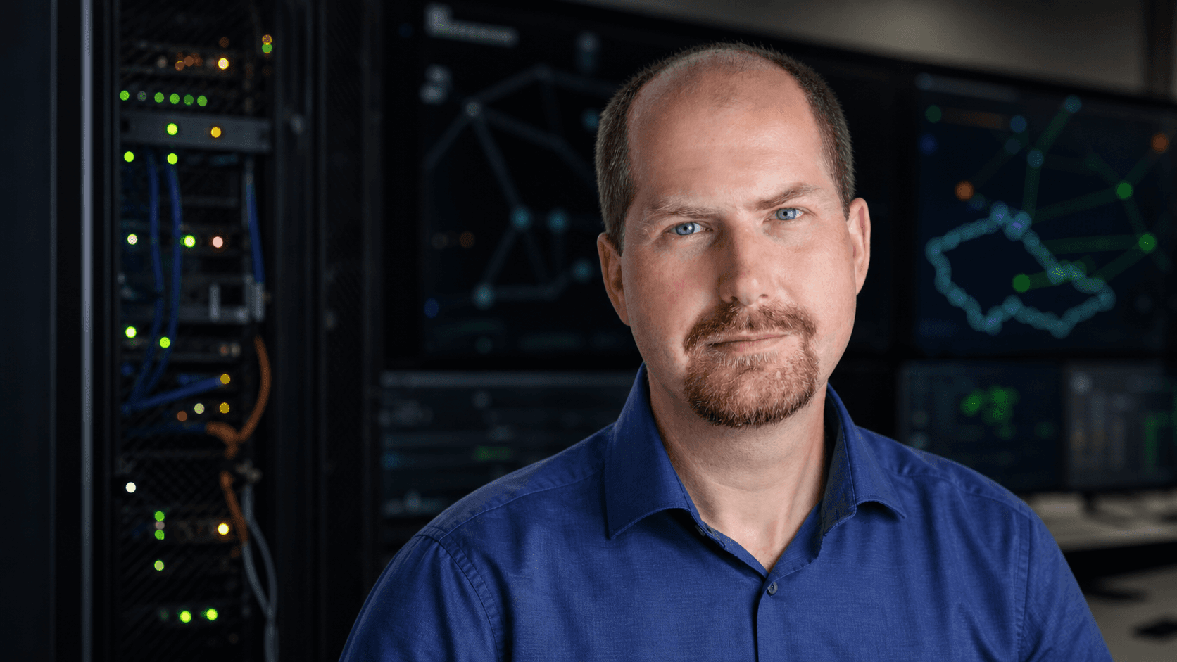 Ondrej Filip in an editorial portrait against a network operations background