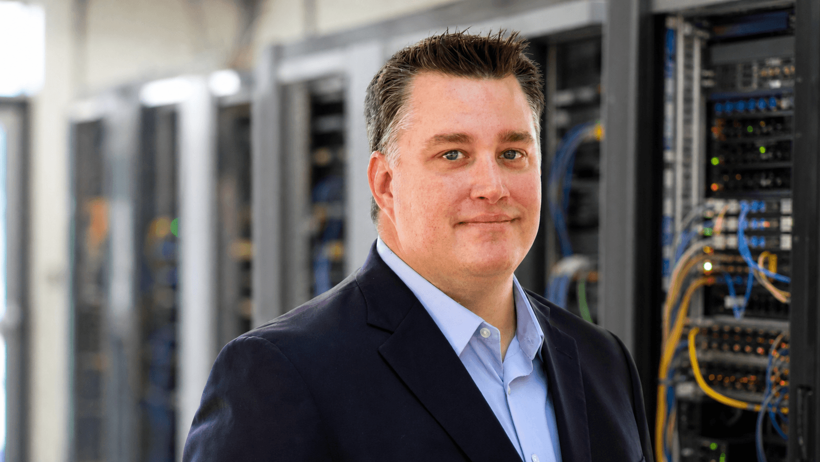 AI editorial portrait of Preston Louis Ursini in a regional network operations setting