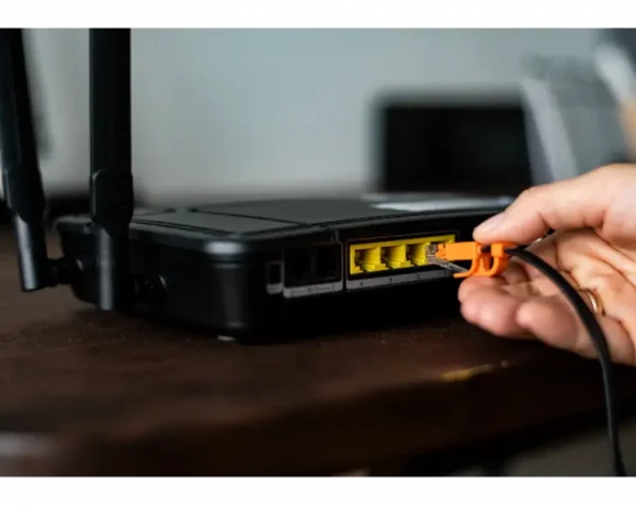 man-plugging-ethernet-cable-wireless-router-1
