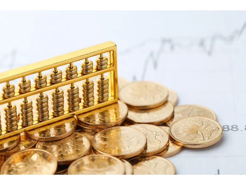 golden-abacus-with-chinese-rmb-gold-coins-as-background
